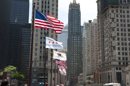 United States flag and National flag of Chicago seen in front of the 333 North Michigan skyscraper, which is an Art Deco in Chicago. It is famous for it's upper level setbacks.の写真素材
