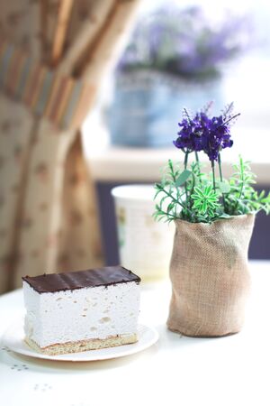 Piece of sweet souffle on a plate in a sunny cafe interiorの写真素材
