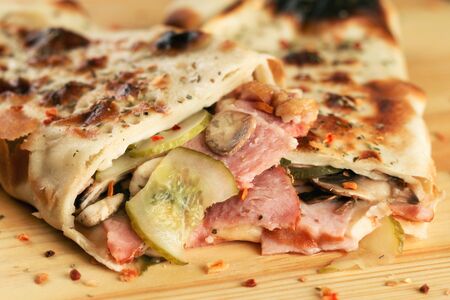 Pizza roll sandwich snack with ham close-up. Shallow depth of fieldの写真素材