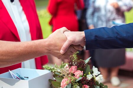 Wedding ceremony. Wedding congratulation shaking hands. Wedding handshakeの写真素材