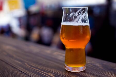 Glass of beer on bar pub festive background. Craft beer festival