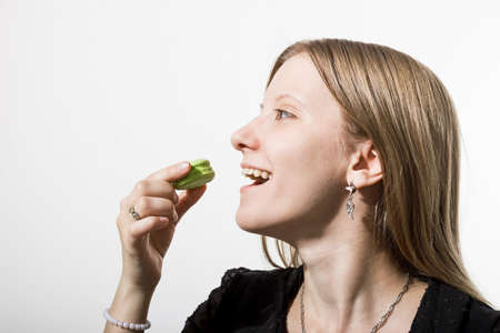 A girl eats a cookie.の写真素材