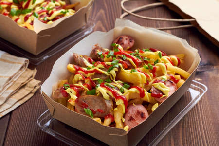 salchipapa, salchipapas traditional street food from Peru with sausages and french fries
