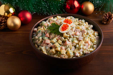 traditional russian salad (olivier) dark brown background new years tree new year tree decorationsの写真素材