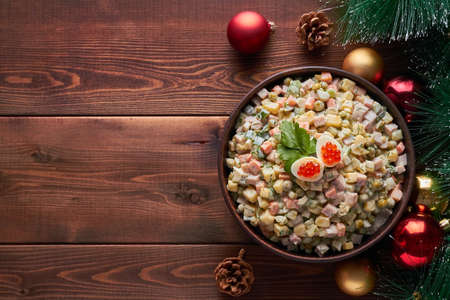 traditional russian salad (olivier) dark brown background new years tree new year tree decorationsの写真素材