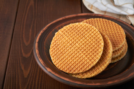 dutch waffles stroopwafel syrup waffle caramel waffle on brown backgroundの写真素材