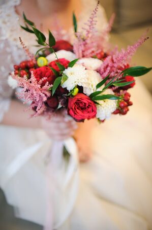 Bride holding a bouquet of beautiful rosesの写真素材