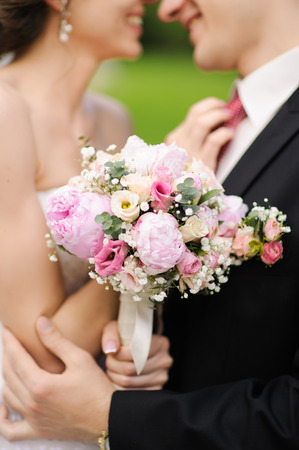 A bride and groom kissing on their wedding dayの写真素材