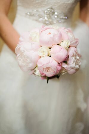 Bride holding a bouquet of beautiful flowersの写真素材