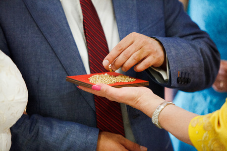 bride and groom are changing rings on weddingの写真素材