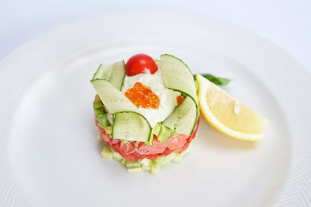 Tartare with salmon on white plate studio shotの写真素材