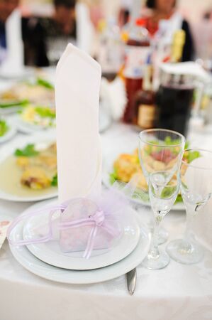 Banquet wedding invitation on table setting on evening reception awaiting guestsの写真素材
