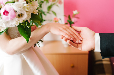 Bride and groom holding handsの写真素材