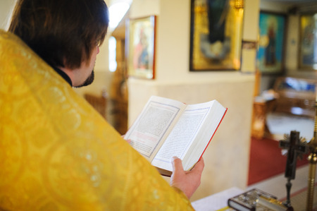 Orthodox priest during christening baptismの写真素材