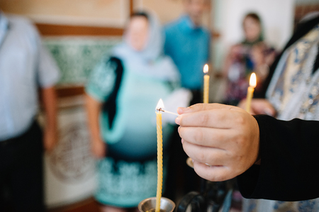 burning thin candle during christening Orthodox baptismの写真素材