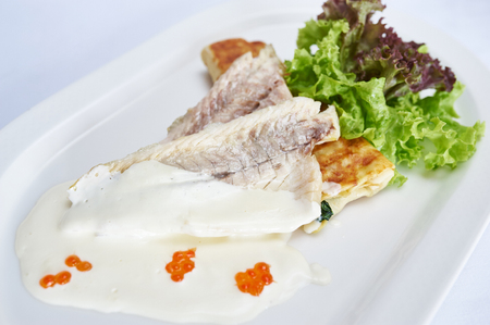 Fillet of sea bass on spinach pancakeの写真素材