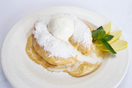 Ice cream profiteroles on white plate studio shotの写真素材