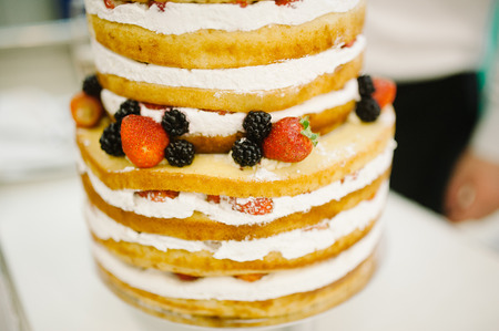 wedding cake decorated with berries and strawberriesの写真素材