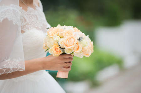 Bride holding a bouquet of flowers, wedding bouquetの写真素材