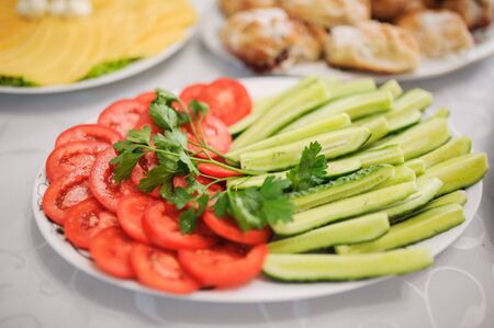 Tasty appetizer. Different vegetables on white plateの写真素材