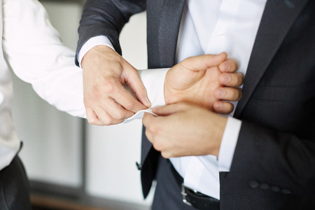 groom getting ready dressed in the morning. buttons in white shirtの写真素材
