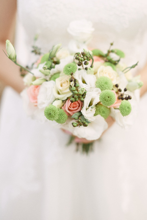 Bridal bouquet. Beautiful bouquet of different colors in the hands of the bride

の写真素材