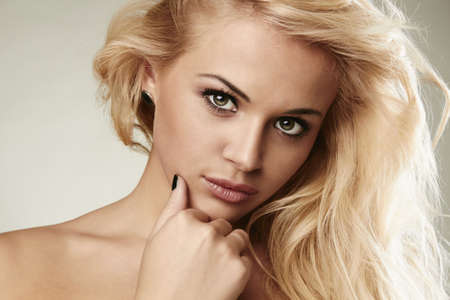 beautiful sensitive blond woman with gold hairの写真素材