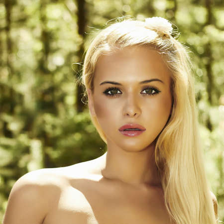Portrait of Beautiful blond woman in forest  summer sunlightの写真素材