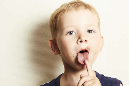 Child  kid boy with chocolate dirty faceの写真素材