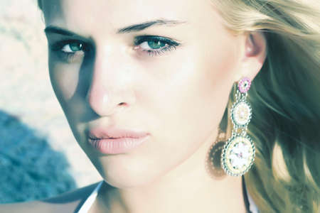 Beautiful mysterious blond woman  stone backgroundの写真素材