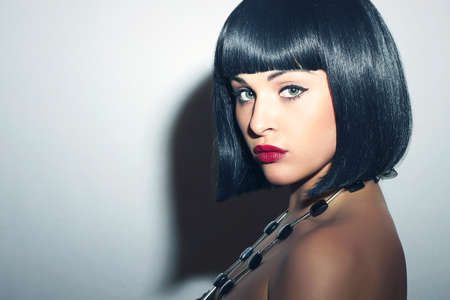 Beautiful Brunette Woman. Healthy Black Hair. bob Haircut. Red lips. Beauty Model.Your text hereの写真素材