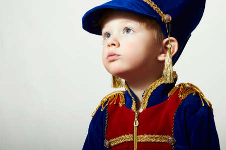 Little Boy in Carnival Costume.Fashion Children.Handsome Kid with big blue eyes. Masquerade Soldier.Unusual Uniformの写真素材