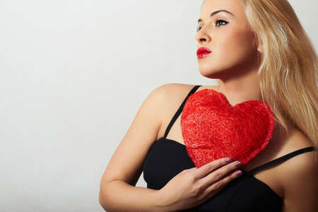 Lovely Beautiful Blond Woman with Red Heart. Beauty Girl. Show Love Symbol. Valentine39s Dayの写真素材