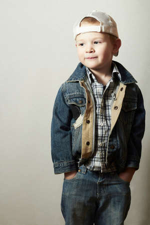Posing Child. Funny Little Boy in Jeans. Trucker cap. joy. Fashionable Kid 4 years old