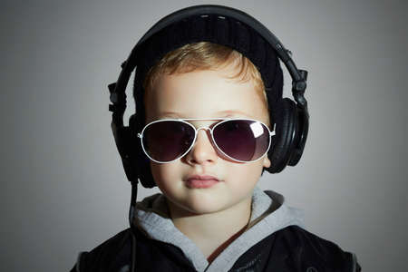 little deejay. funny smiling boy in sunglasses and headphones.5 years old child listening music in headphones. DJ kidsの写真素材