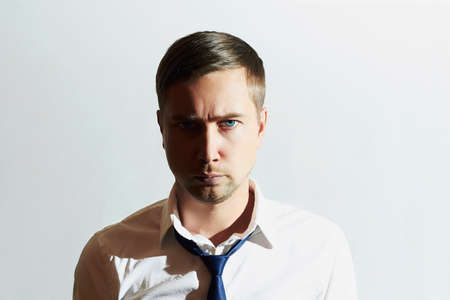 Tired man. Businessman. Young man in tie. Work hard conceptの写真素材