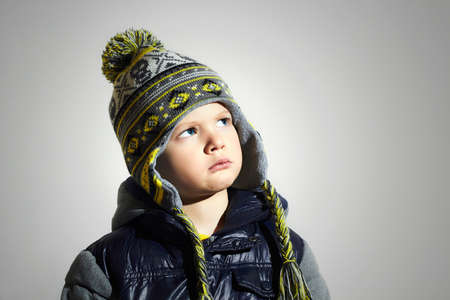 child with blue eyes.fashion kids.fashionable little boy in winter cap