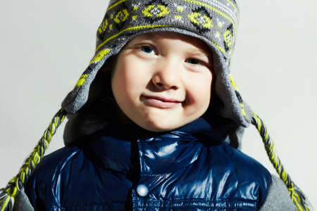handsome little boy.funny smiling child.winter fashion kids.fashionable boy in winter capの写真素材