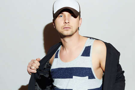Handsome Man. Stylish Boy in cap. Casual Fashion.posing Young man model