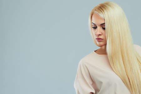 beautiful young woman in light dress.Fashionable Sexy blond girl.healthy hairの写真素材