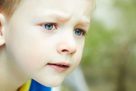 Photo of adorable young funny boy. Outdoor face of child