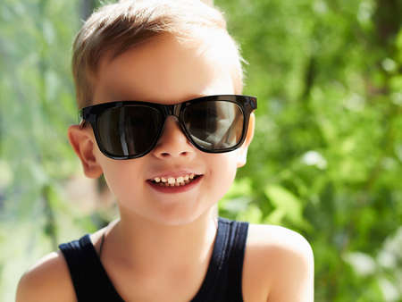 smiling young handsome boy in sunglasses.Outdoor fashion child