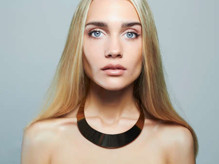 Young blond woman.Beautiful Girl.close-up fashion portrait.blonde in necklaceの写真素材