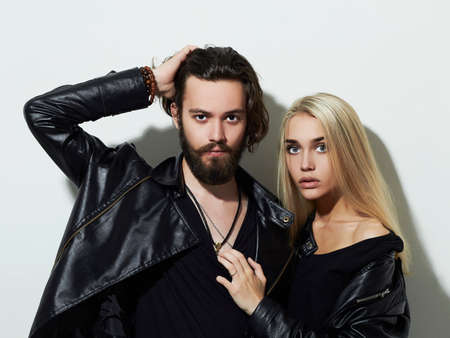 Hipster boy and girl. Bearded young man and blonde model