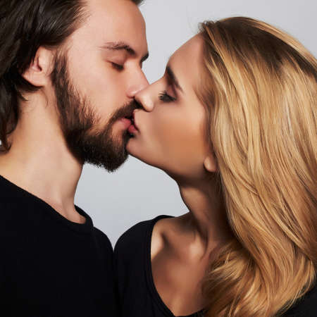 Kissing couple portrait.romantic beautiful young woman and handsome man.lovely boy and girlの写真素材