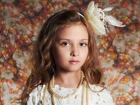 fashion portrait of beautiful little girl. floral background.funny childの写真素材