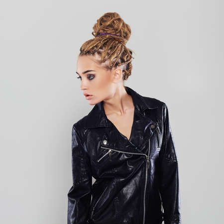 sexy beautiful girl with dreadlocks hairstyle. punk rock young woman in leatherの写真素材
