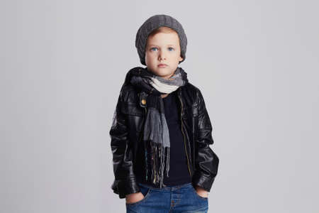 handsome boy in scarf.Funny child in hat.fashionable little boy.stylish kid in leather coatの写真素材