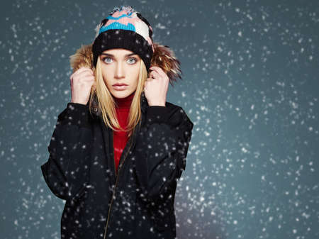 snowy winter style girl. fashion beautiful young woman in hat.happy winter time