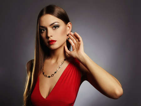 young beautiful sexy woman with big breasts.Beauty brunette girl with perfect body.elegant lady in red dress.plastic surgeryの写真素材